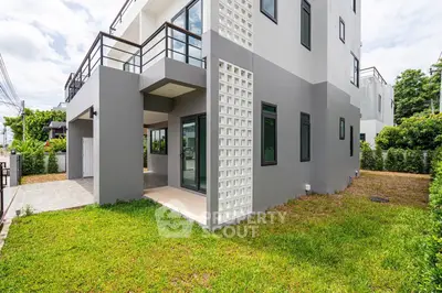 Modern corner unit townhouse with spacious garden and sleek exterior design.