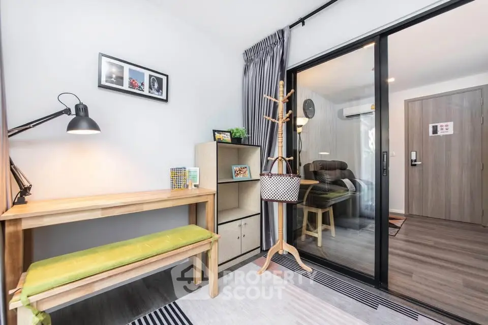 Modern study area with wooden desk and sliding glass door to cozy bedroom