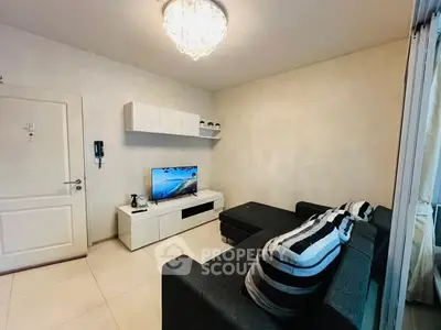 Modern living room with sleek black sofa and wall-mounted TV unit