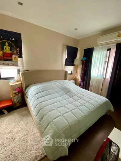 Cozy bedroom with large bed and natural light, perfect for relaxation and comfort.