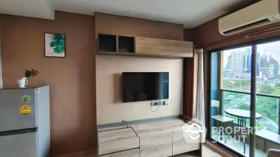 Modern living room with city view balcony and sleek entertainment center.