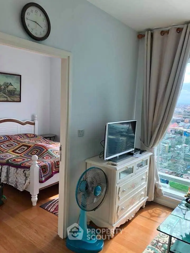 Charming bedroom with city view, elegant decor, and cozy ambiance.