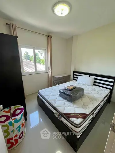 Cozy bedroom with large window and modern furnishings