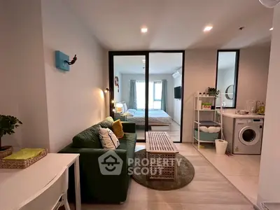 Modern studio apartment with cozy living area and in-unit laundry