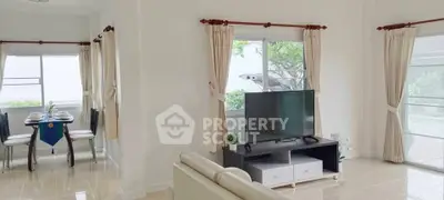 Bright living room with modern decor and adjacent dining area