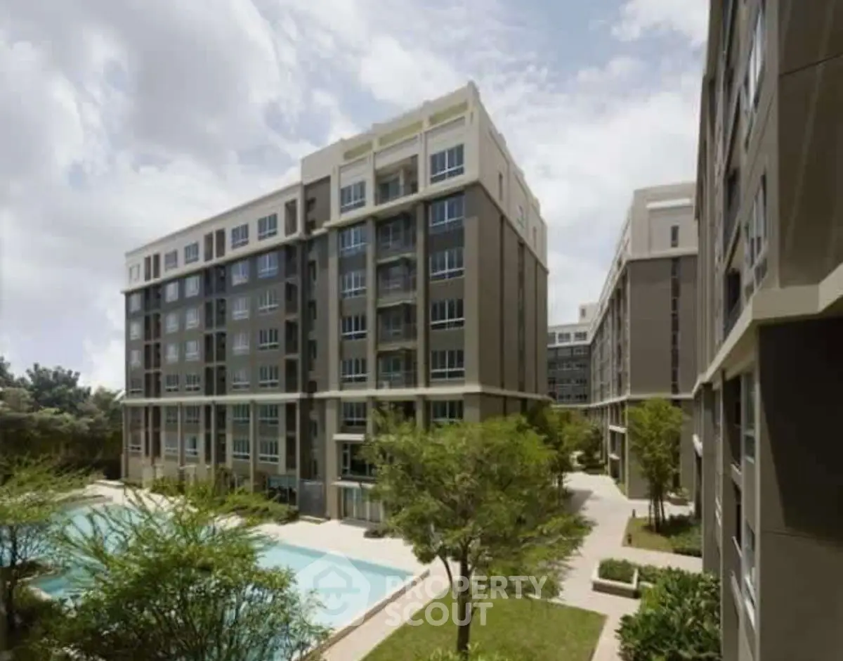 Modern apartment complex with lush greenery and pool view