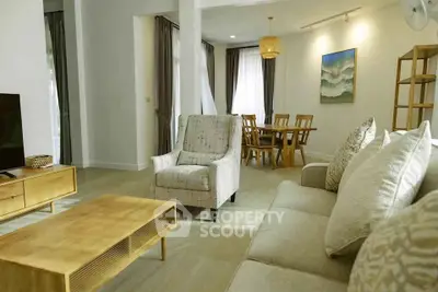 Spacious living room with modern furniture and dining area in open layout
