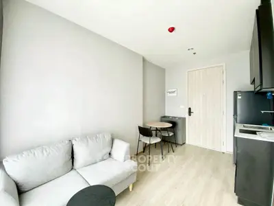 Modern living room with cozy sofa and dining area in a compact apartment