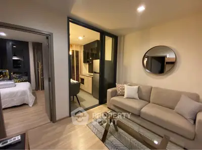 Modern living room with open kitchen and cozy bedroom view