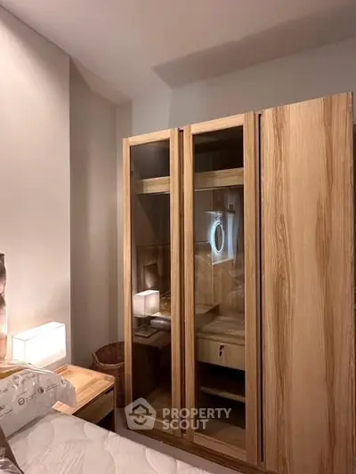Cozy bedroom with wooden wardrobe and soft lighting