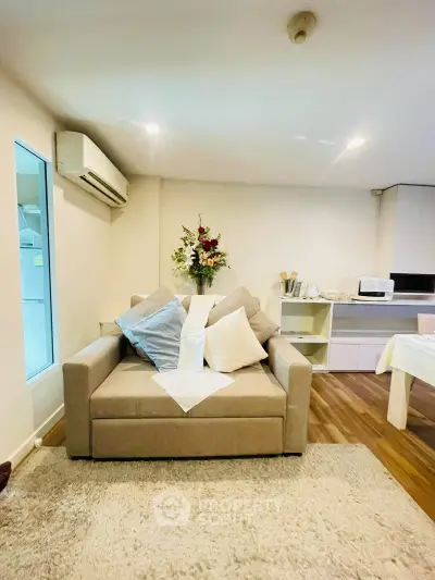 Cozy living room with modern decor and plush seating in a stylish apartment.