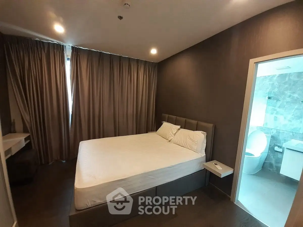 Modern bedroom with ensuite bathroom and elegant lighting