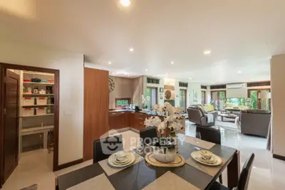 Spacious open-plan living and dining area with modern decor and garden view.