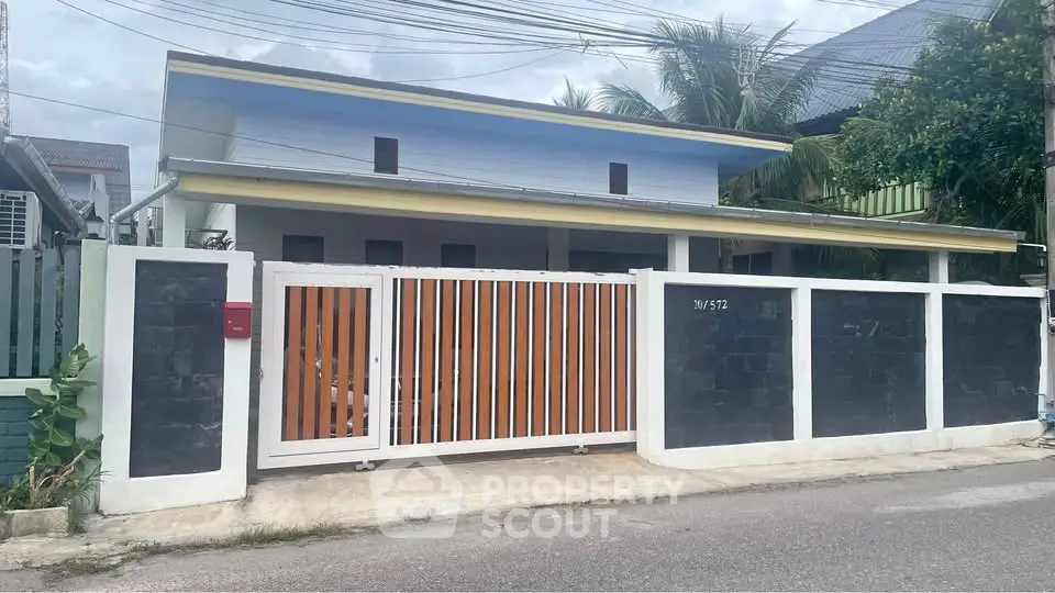 Charming single-story home with gated entrance and modern facade in a serene neighborhood.