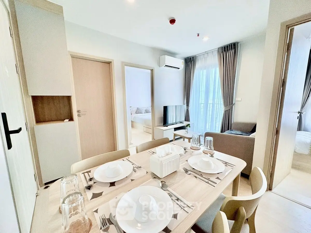 Modern open-plan living and dining area with stylish decor and natural light.