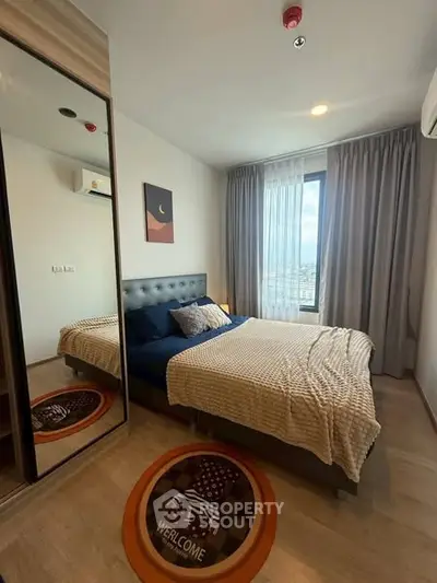 Modern bedroom with stylish decor and large window offering city view