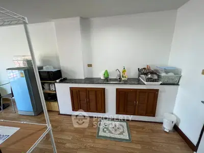 Charming kitchen with wooden cabinets and modern appliances, perfect for culinary enthusiasts.