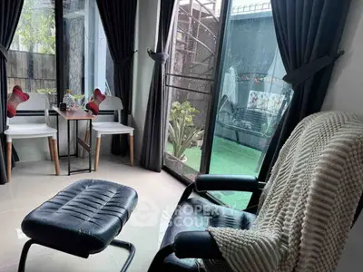 Cozy living room with modern furniture and garden view, perfect for relaxation.