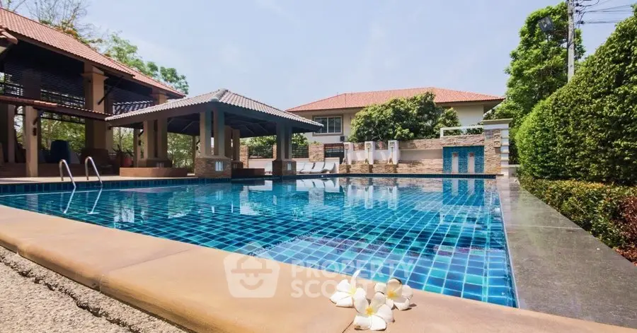 Luxurious outdoor pool area with modern design and lush greenery, perfect for relaxation and leisure.