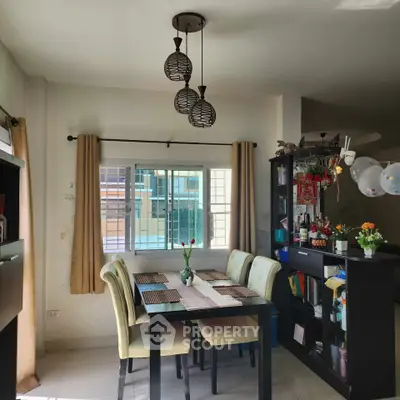 Charming dining area with modern lighting and cozy decor, perfect for family gatherings.