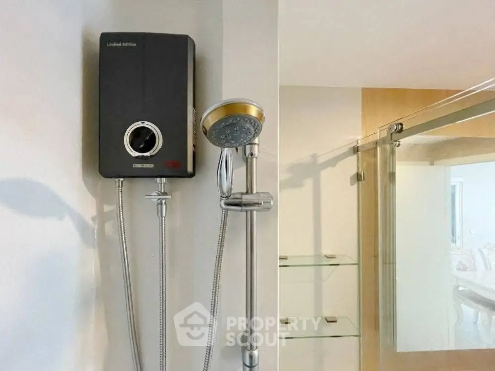 Modern bathroom with sleek showerhead and glass shelving, perfect for contemporary living.