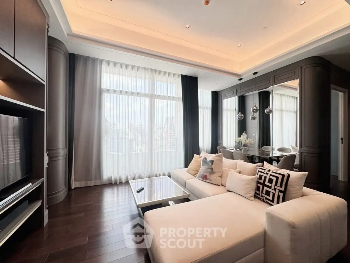 Luxurious living room with elegant decor and large windows offering stunning city views.