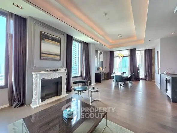 Luxurious modern living room with elegant decor and large windows offering stunning city views.