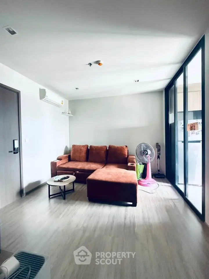 Modern living room with stylish sofa and natural light, perfect for relaxation and comfort.