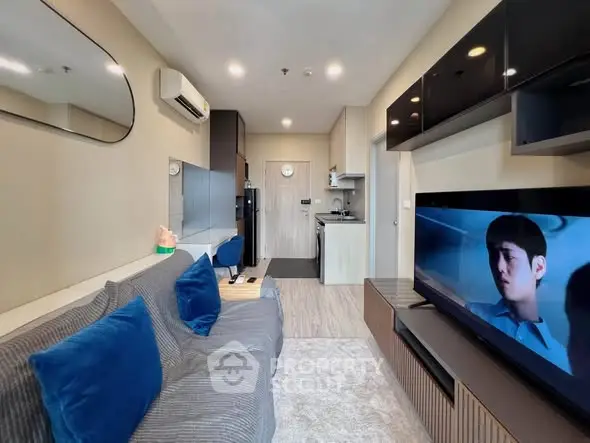 Modern living room with sleek furniture and wall-mounted TV in a stylish apartment.