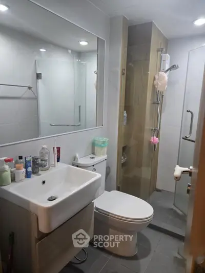 Modern bathroom with sleek fixtures and glass shower enclosure