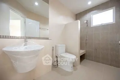 Spacious modern bathroom with elegant fixtures and natural light