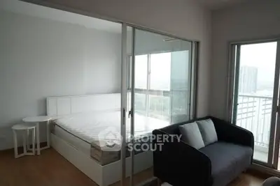 Modern bedroom with glass sliding doors and balcony view