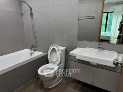 Modern bathroom with bathtub and sleek fixtures in a contemporary apartment.
