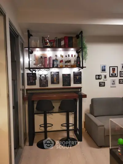 Stylish home bar setup with shelves, stools, and wall decor in cozy living area.