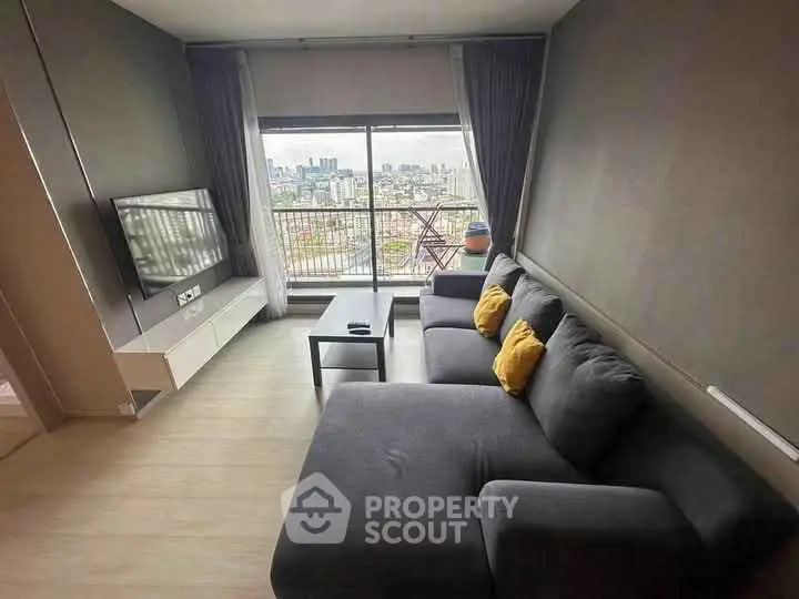 Modern living room with city view and stylish gray sofa