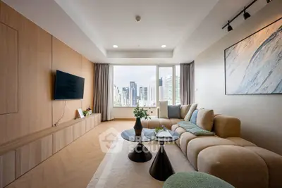 Modern living room with city view, stylish furniture, and elegant decor in a high-rise apartment.