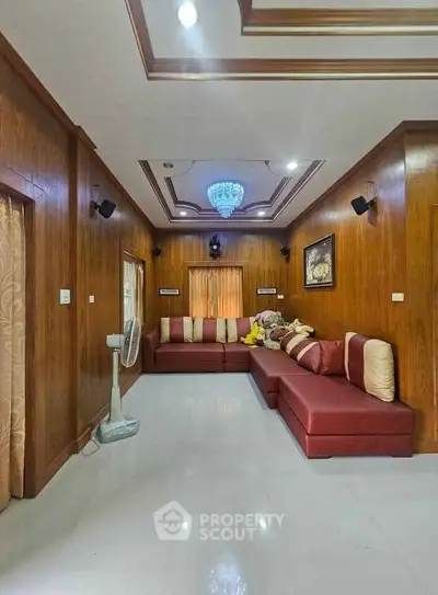 Spacious living room with elegant wooden paneling and modern lighting