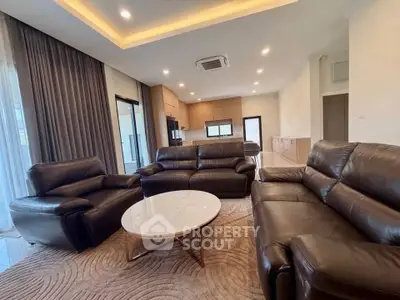 Luxurious living room with leather sofas and modern open kitchen design