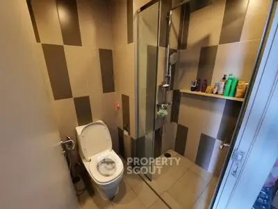 Modern bathroom with glass shower and tiled walls