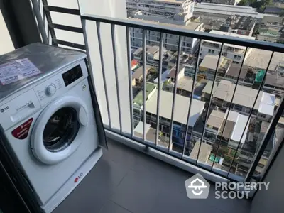 High-rise balcony with washing machine and city view