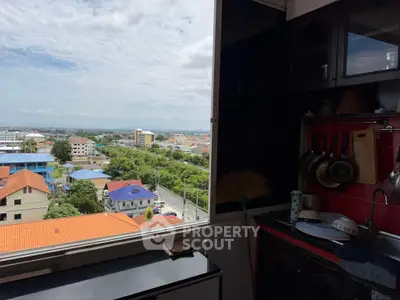 Spacious kitchen with a stunning city view, featuring modern cabinets and a sleek countertop.
