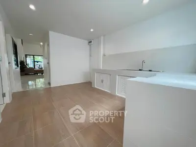 Spacious kitchen with modern open layout and sleek tile flooring