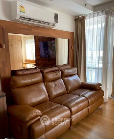 Luxurious living room with leather sofa and large window view