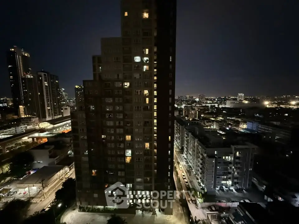 Stunning night view of urban high-rise buildings with city lights, perfect for modern living.