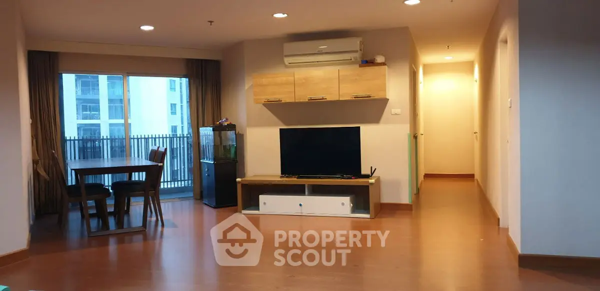 Spacious living room with modern decor and balcony view in a stylish apartment.