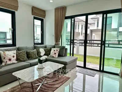 Modern living room with large windows and stylish decor in a contemporary home.