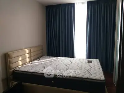 Cozy bedroom with elegant curtains and comfortable mattress