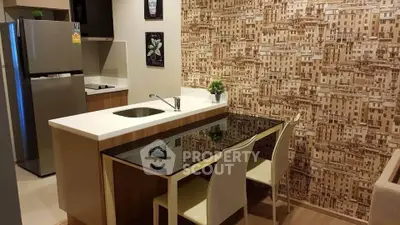 Modern kitchen with stylish wallpaper and sleek appliances in a cozy apartment setting.