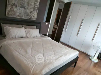 Spacious modern bedroom with elegant decor and ample storage space