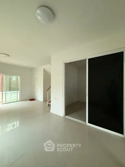 Spacious modern living area with sliding glass doors and natural light